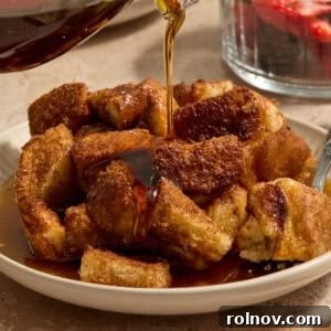 Maple syrup being poured over French toast casserole.