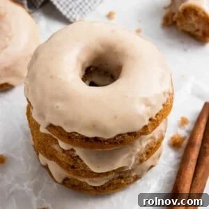 Apple donuts with apple cider glaze stacked.