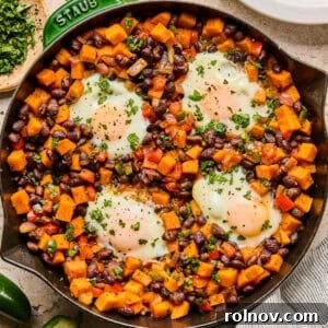 Sweet potato breakfast hash with black beans in a skillet.