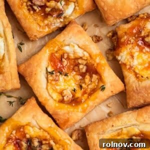 Golden puff pastry squares featuring creamy goat cheese and sweet apricot jam, an easy and elegant appetizer.