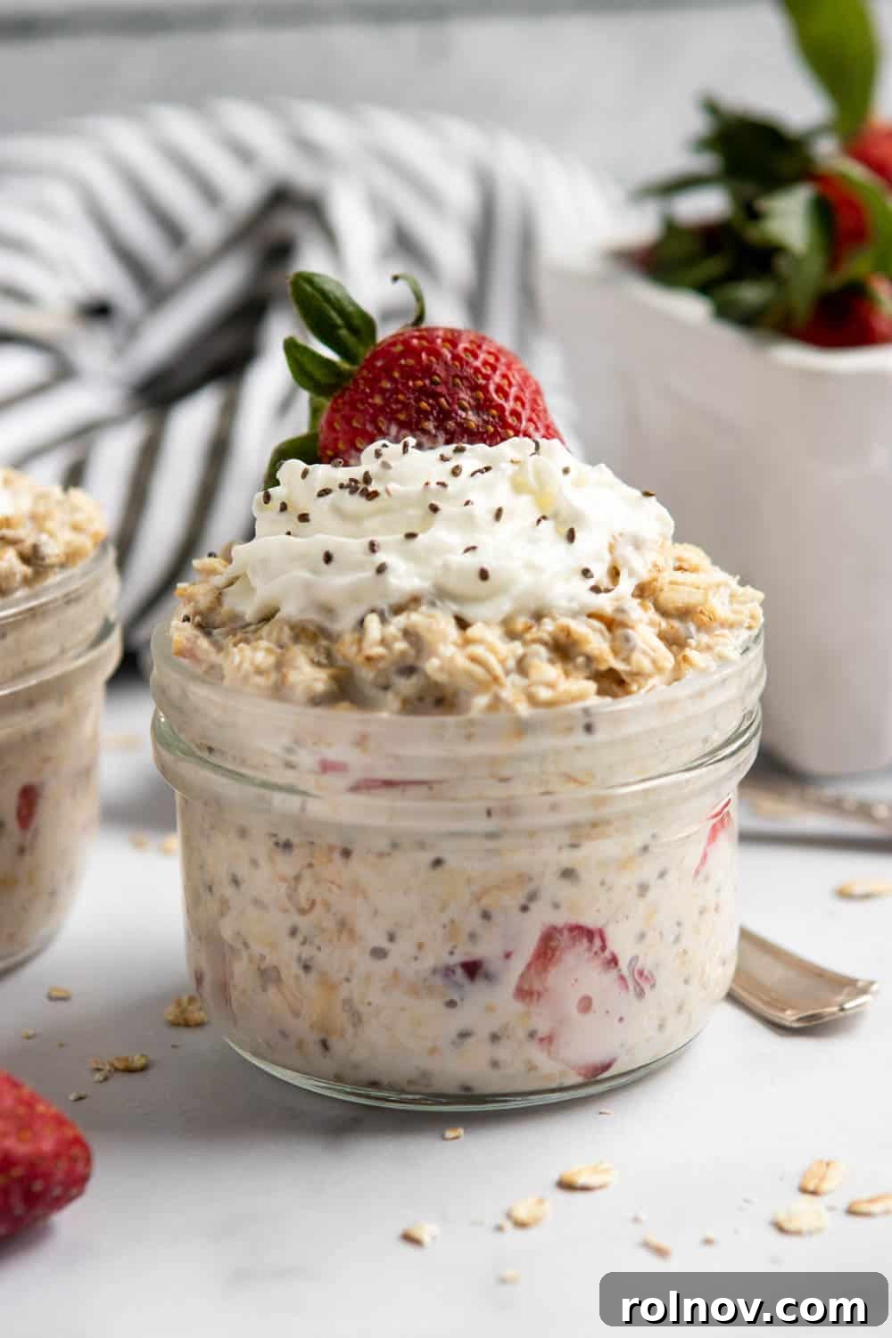 Dreamy Strawberry Shortcake Overnight Oats 3 Close-up of Strawberry Shortcake Overnight Oats in a jar, showcasing layers of mashed strawberries and creamy oat mixture, ready for a quick breakfast.