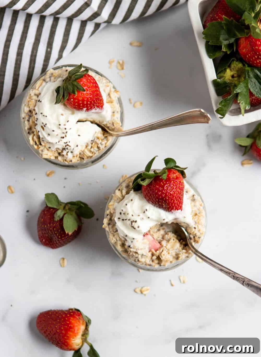 Dreamy Strawberry Shortcake Overnight Oats 4 Overhead view of Strawberry Shortcake Overnight Oats in a glass jar with fresh strawberry slices, highlighting the healthy and convenient aspects of this breakfast.