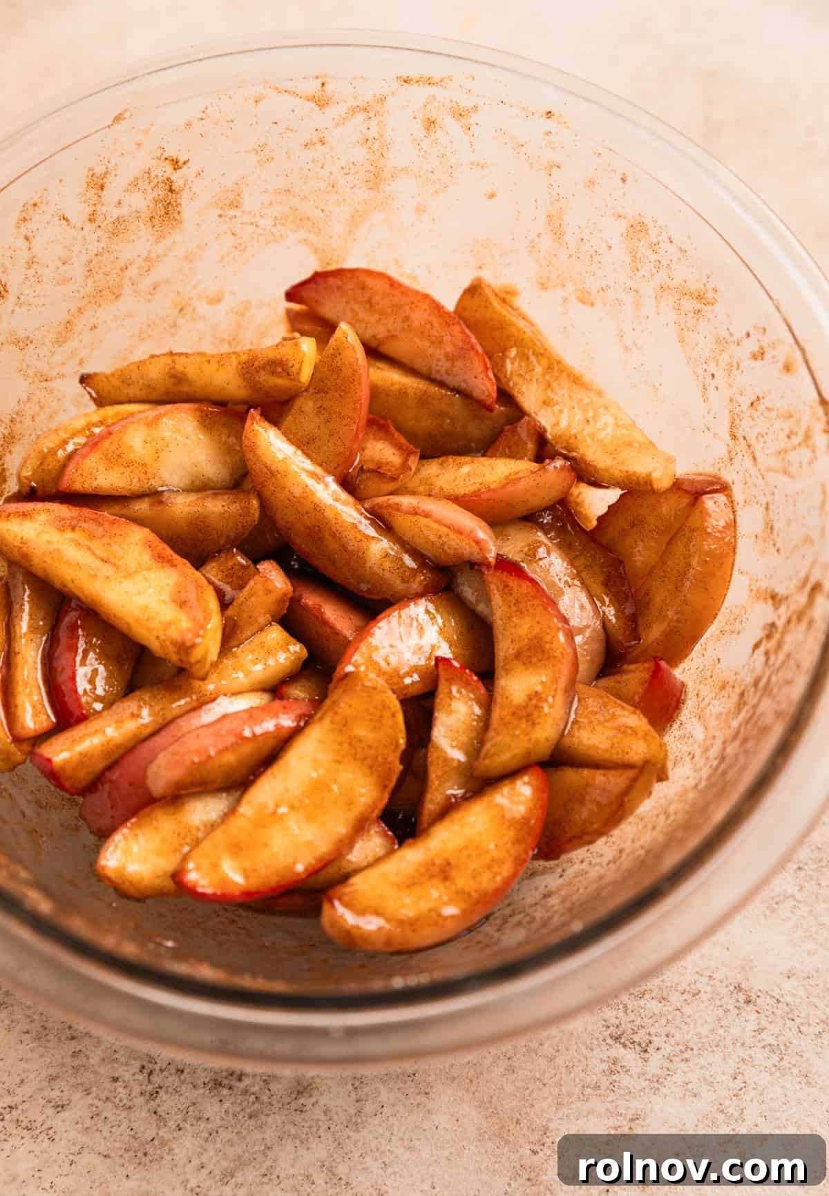 Air Fryer Cinnamon Apple Slices 7 Close-up of freshly cooked apple slices generously tossed in butter, cinnamon, and sugar, ready to be served.