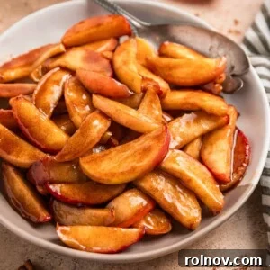 Plate with cinnamon sugar apples and serving utensil.