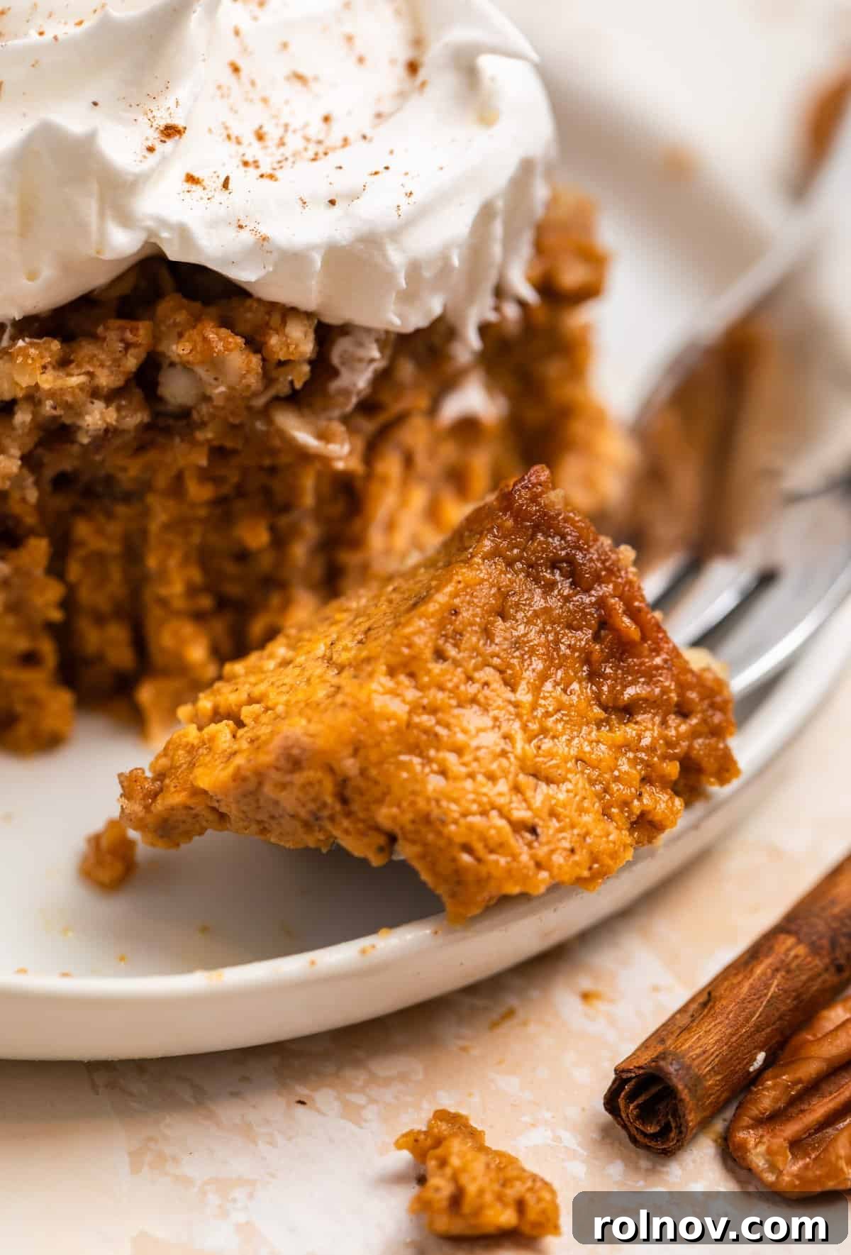Spiced Pumpkin Crumble 14 Fork with pumpkin crumble piece on it beside a slice of the dessert.