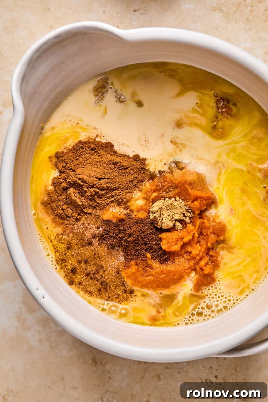 Spiced Pumpkin Crumble 5 Pumpkin, butter, evaporated milk, sugar, and other ingredients in bowl before mixing.