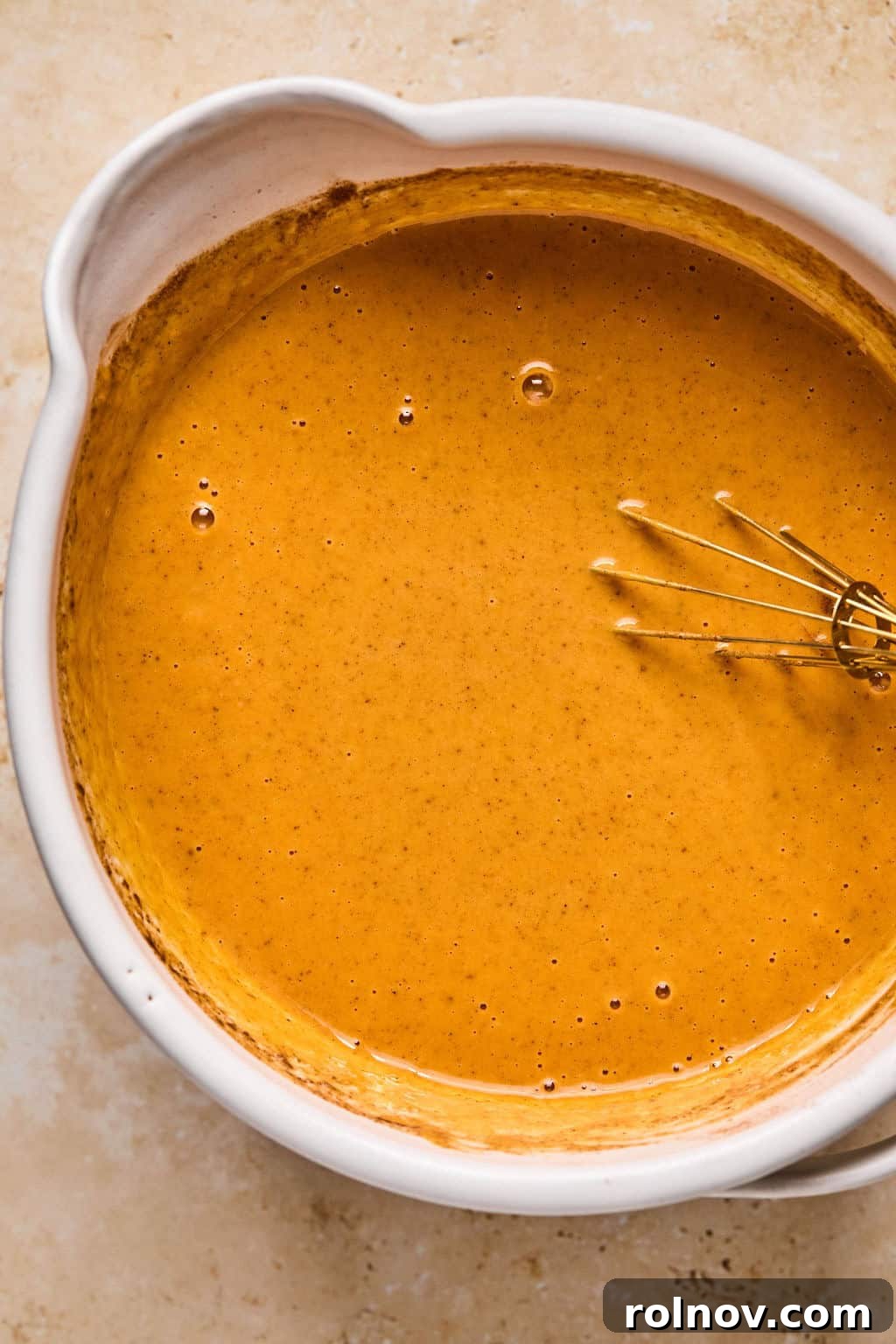 Spiced Pumpkin Crumble 6 Pumpkin pie mixture in bowl with whisk.