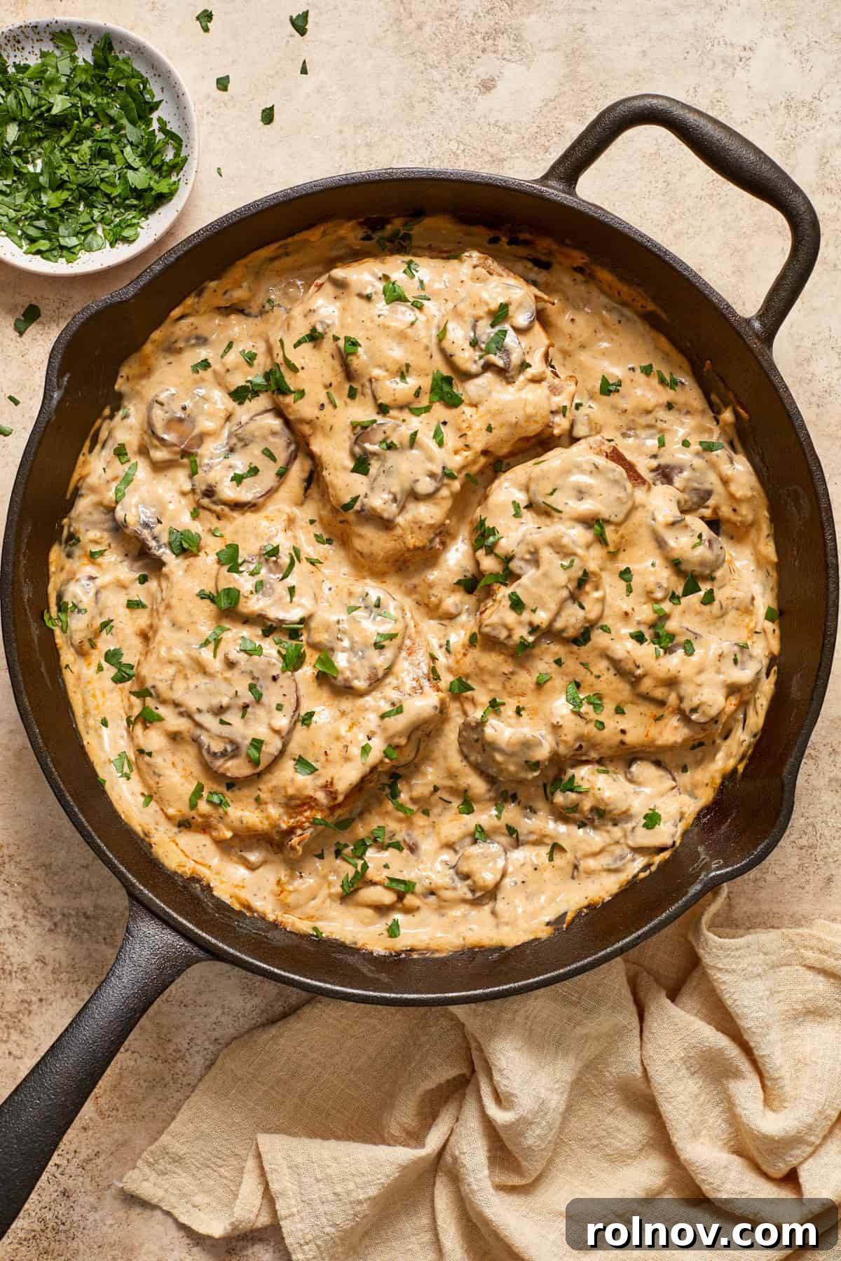 Velvety Mushroom Pork Chops 4 Overhead view of pork chops in cream of mushroom sauce with mushrooms on top.