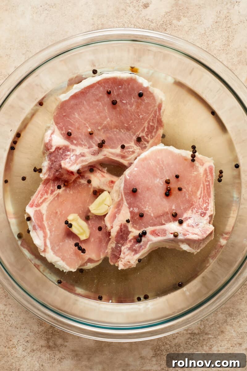 Velvety Mushroom Pork Chops 7 Pork chops in brine in glass bowl.