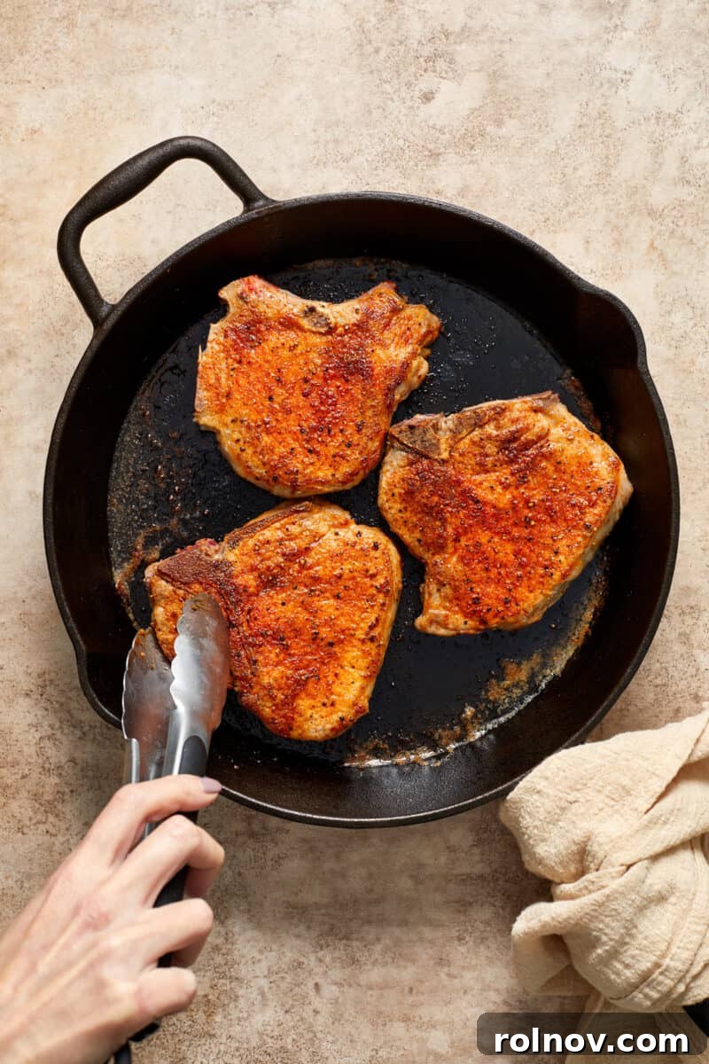 Velvety Mushroom Pork Chops 9 Browned pork chops in skillet.