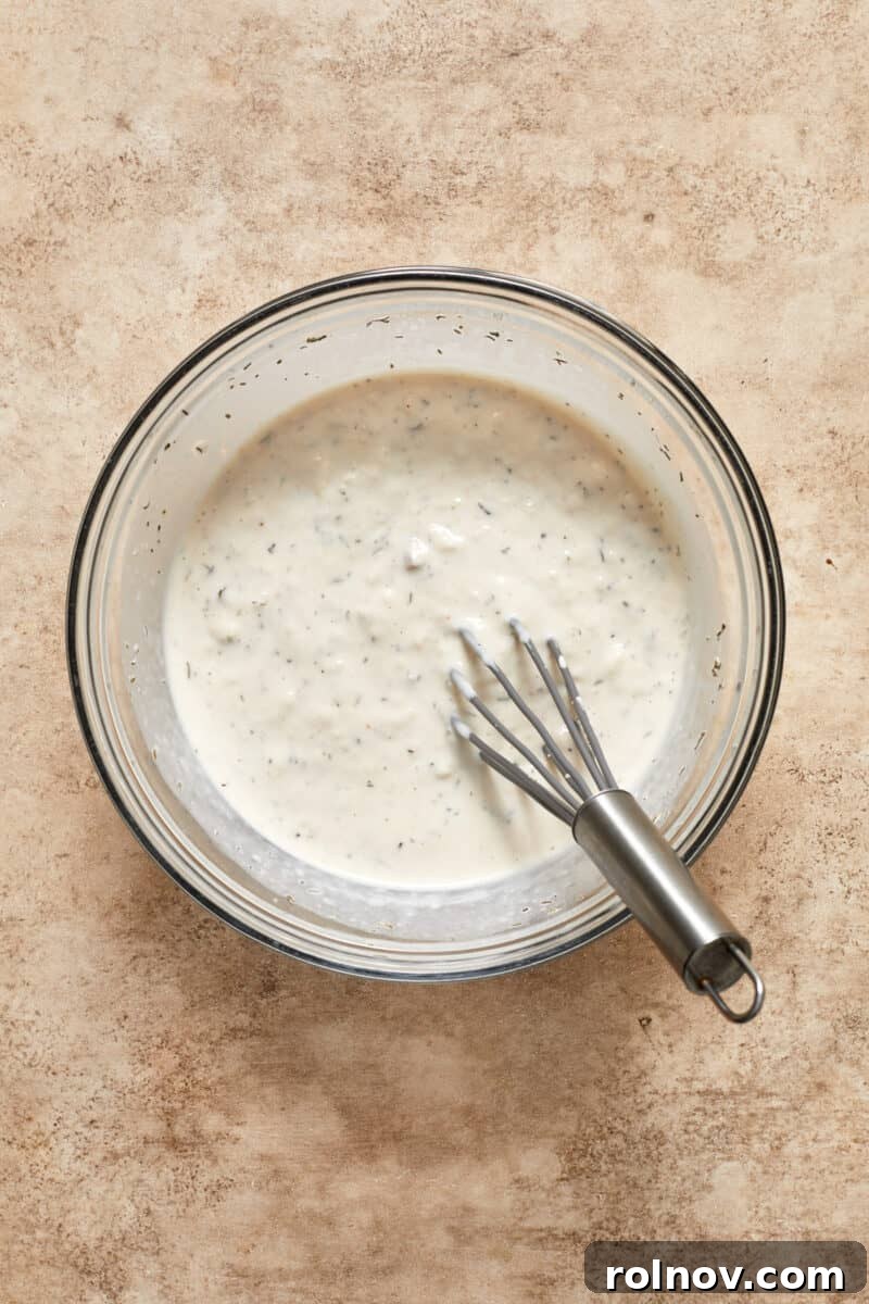 Velvety Mushroom Pork Chops 10 Cream of mushroom mixture in bowl with whisk.