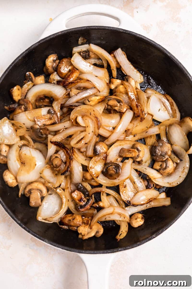Ultimate French Dip Sliders 4 Caramelized onions and mushrooms in skillet, now deeply golden brown and tender.
