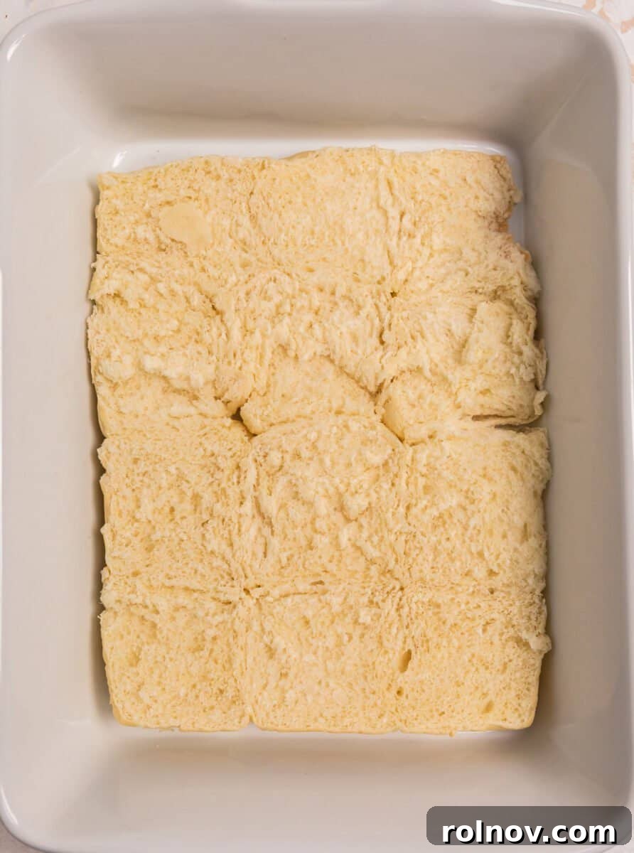 Ultimate French Dip Sliders 5 Bottom layer of Hawaiian rolls neatly arranged in a baking dish, still connected.