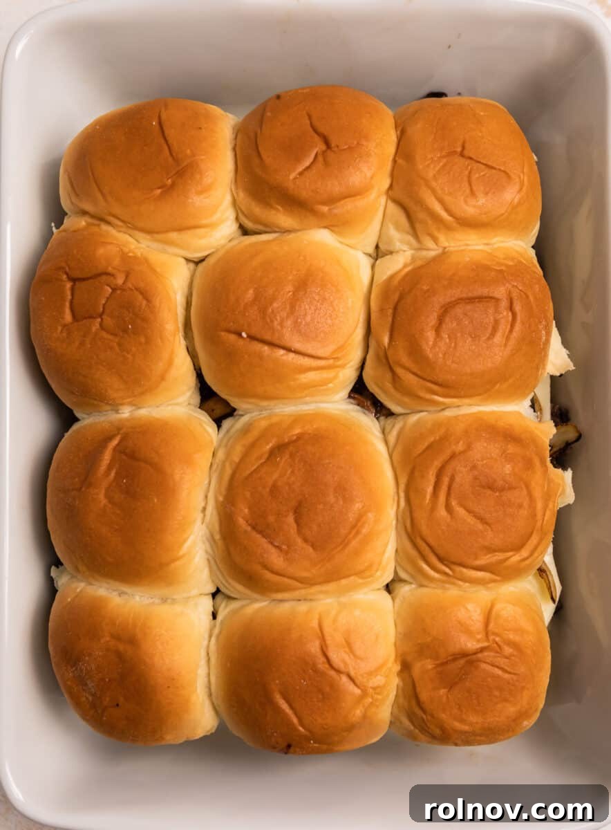 Ultimate French Dip Sliders 9 Top layer of Hawaiian rolls placed back onto the assembled sandwiches in the baking pan.