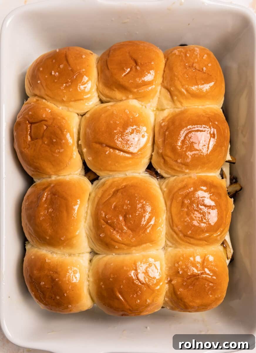 Ultimate French Dip Sliders 10 Buttered tops of rolls in baking dish, glistening and ready for the oven.