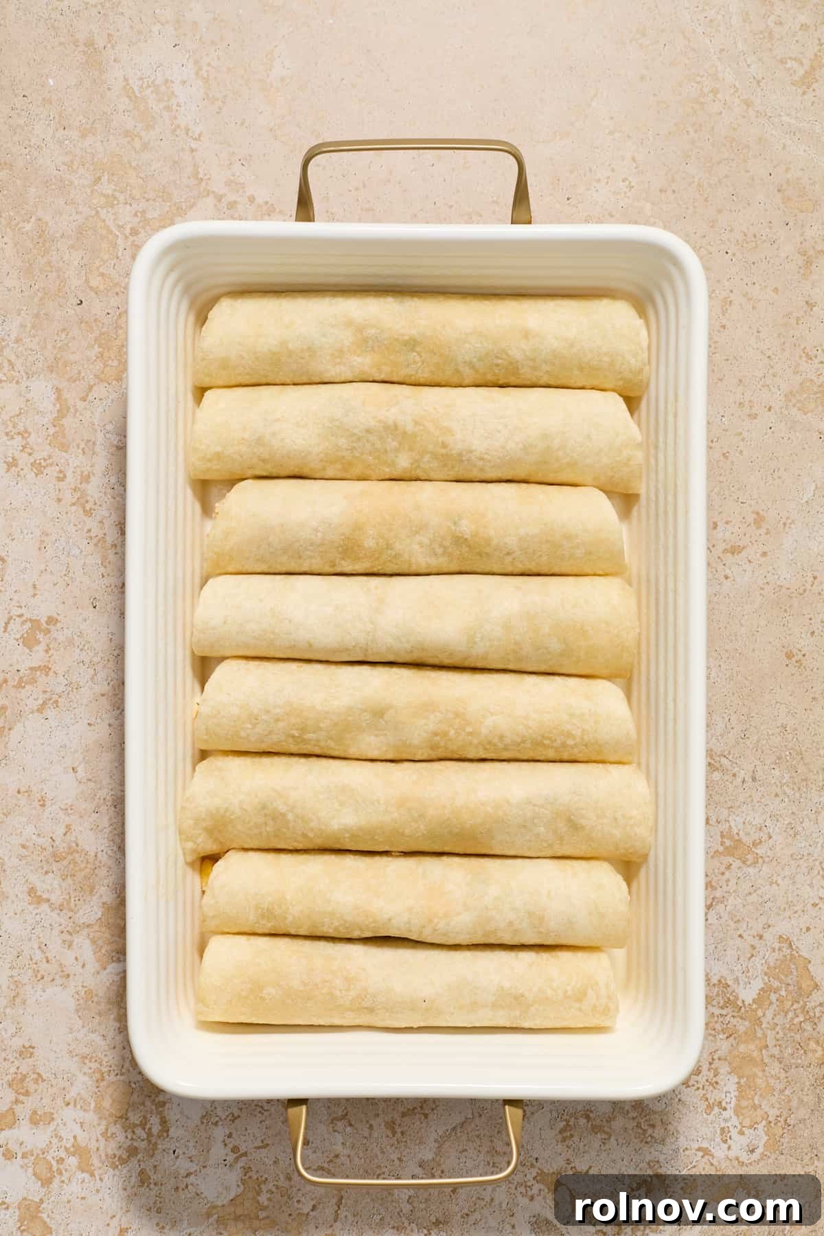 Zesty Verde Chicken Enchiladas 7 Rolled tortillas with green chicken enchilada mixture in pan.