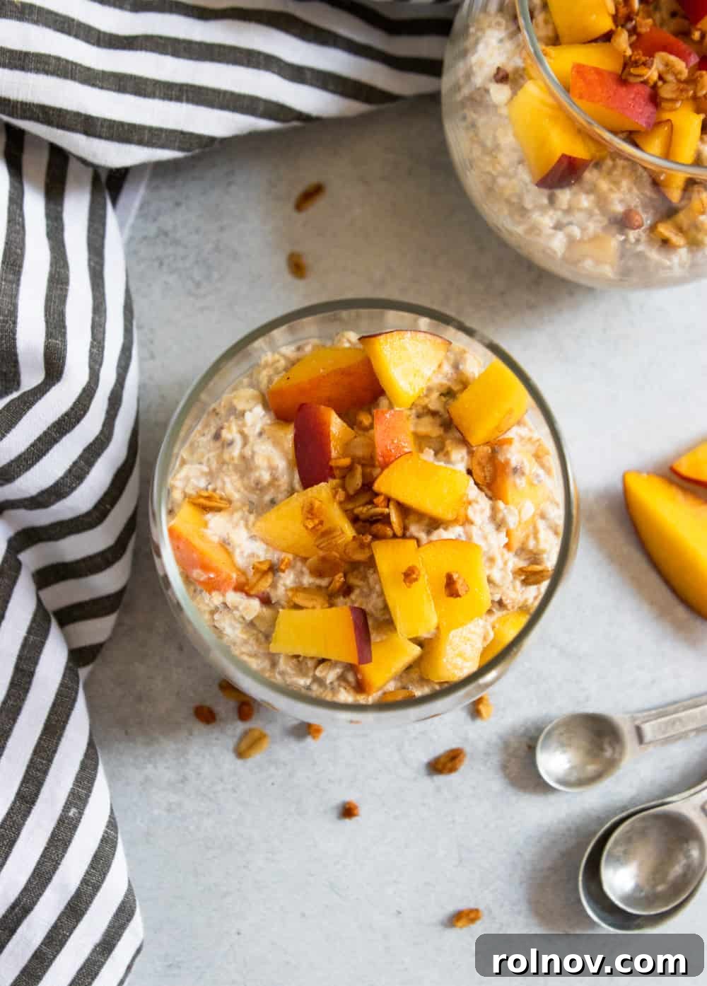 Peach Pie Bliss Overnight Oats 4 Overhead shot of a clear glass jar filled with Peach Overnight Oats, showing layers and textures, ready for breakfast.