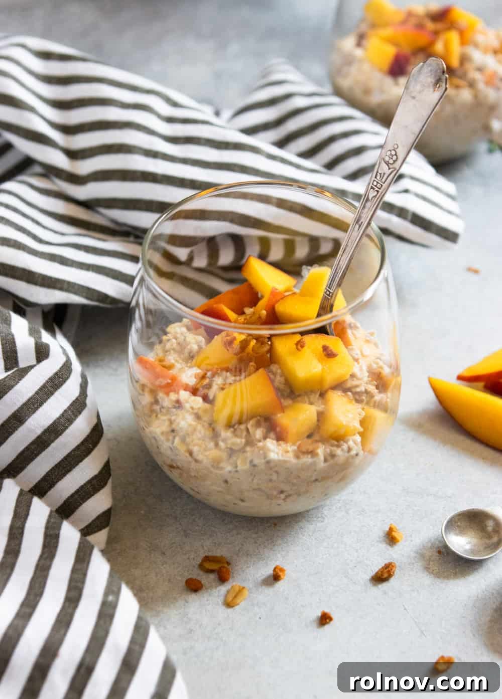 Peach Pie Bliss Overnight Oats 5 Close-up shot of Peach Pie Overnight Oats in a glass jar, showcasing the creamy texture and peach chunks.