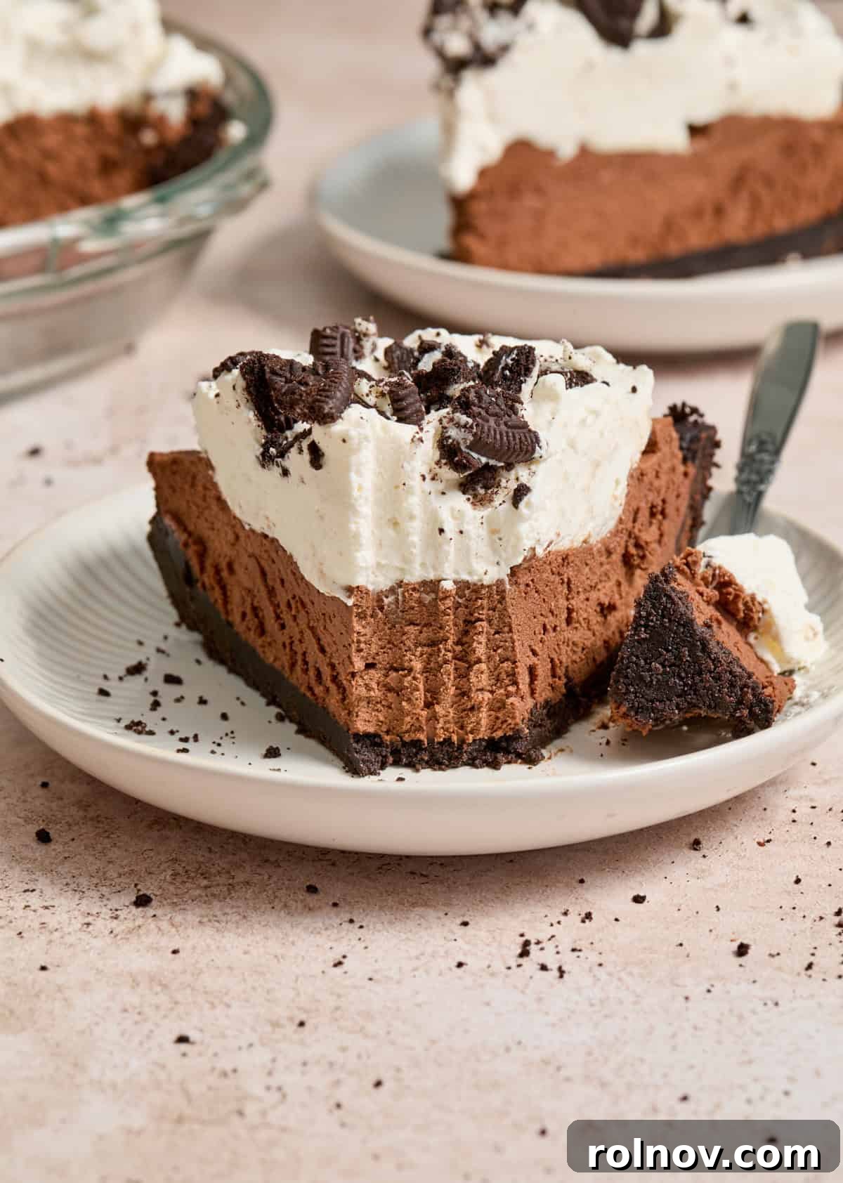 Velvety No Bake Chocolate Pie 2 Slice of no bake chocolate cream pie on white plate with forkful taken out.