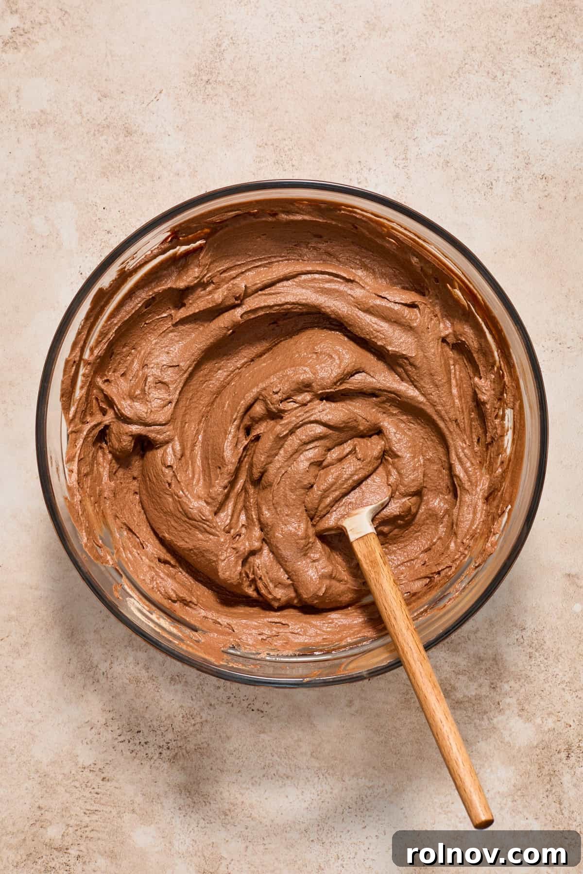 Velvety No Bake Chocolate Pie 11 Chocolate whipped cream folded into chocolate ganache with spatula in mixture.