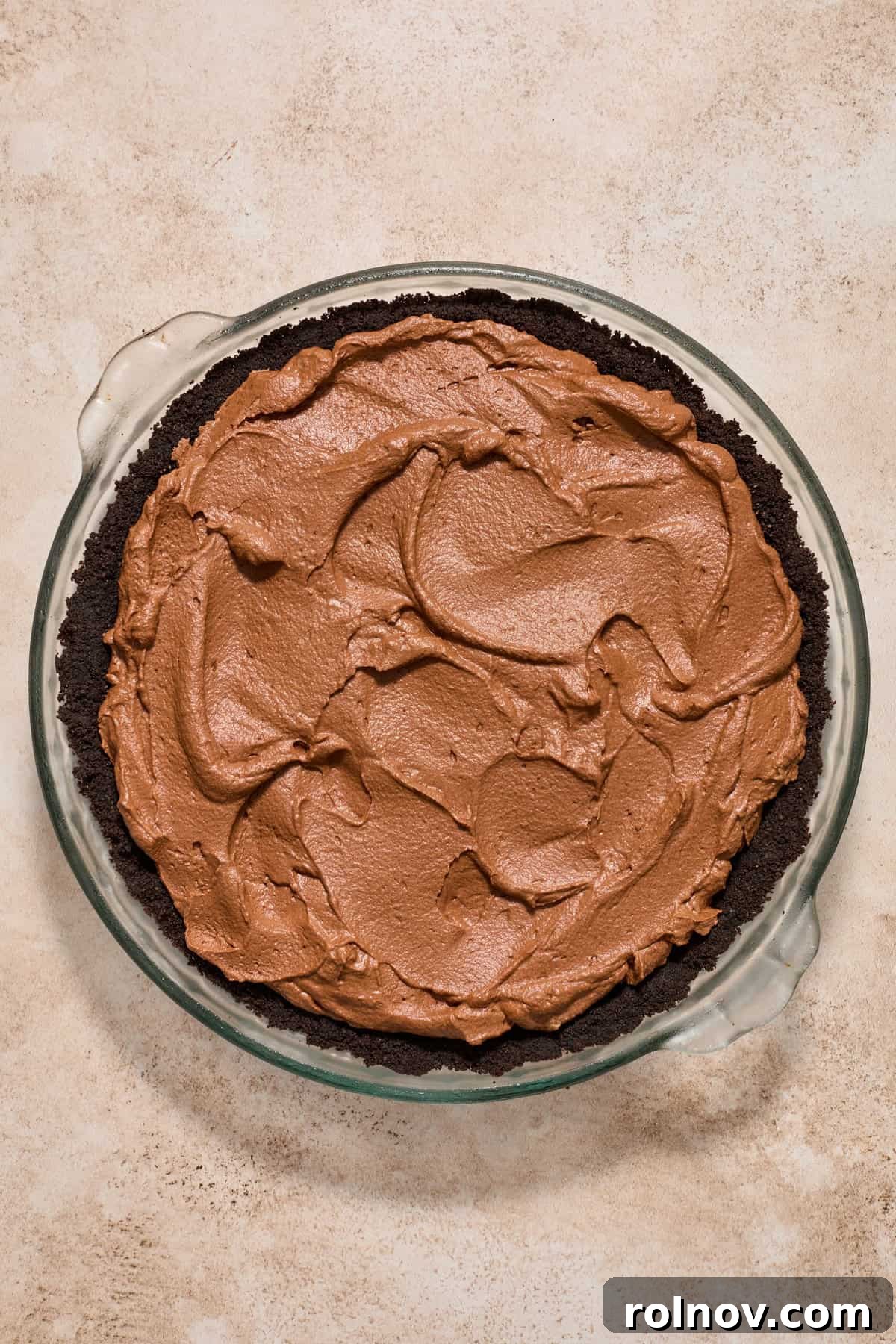 Velvety No Bake Chocolate Pie 12 Chocolate pie filling spread into Oreo crust pie pan.