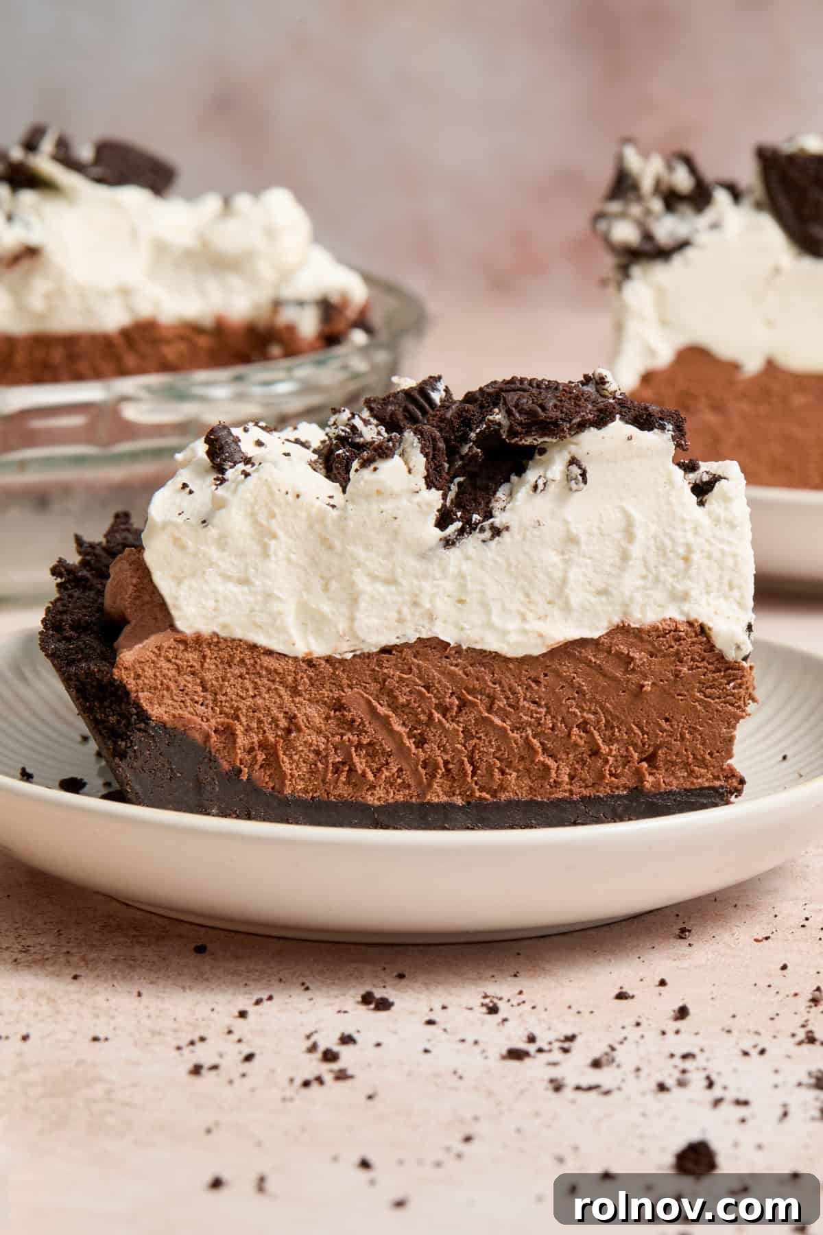 Velvety No Bake Chocolate Pie 14 Slice of no bake chocolate pie with Oreo crust on pie plate topped with crushed Oreos.