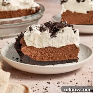 Velvety No Bake Chocolate Pie 15 Slice of chocolate pie with chocolate Oreo crust and whipped cream topping.