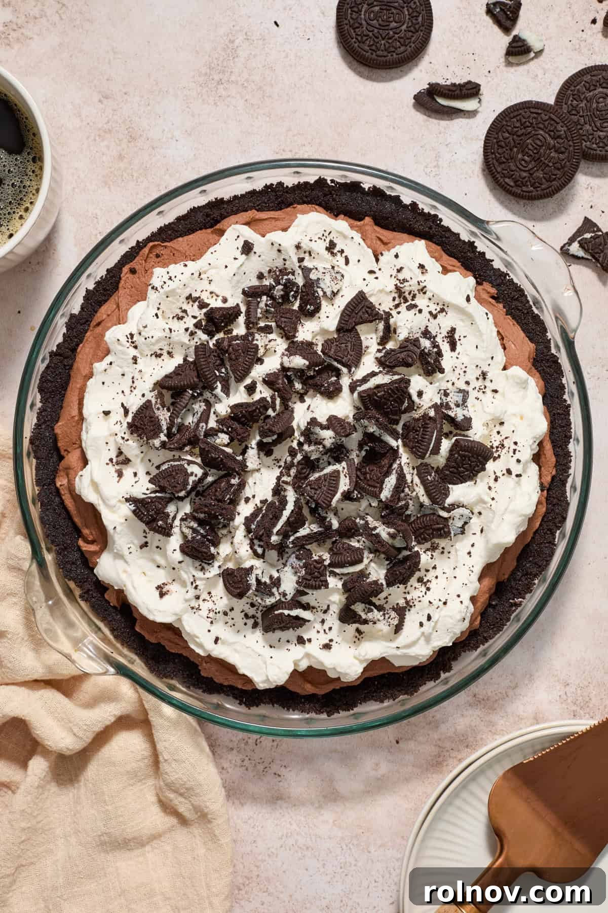 Velvety No Bake Chocolate Pie 3 Overhead view of chocolate pie topped with whipped cream and chopped Oreos.