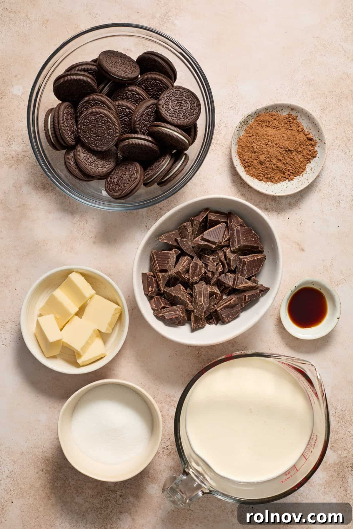 Velvety No Bake Chocolate Pie 4 Oreo cookies, cocoa powder, heavy cream, butter and other ingredients arranged on surface.