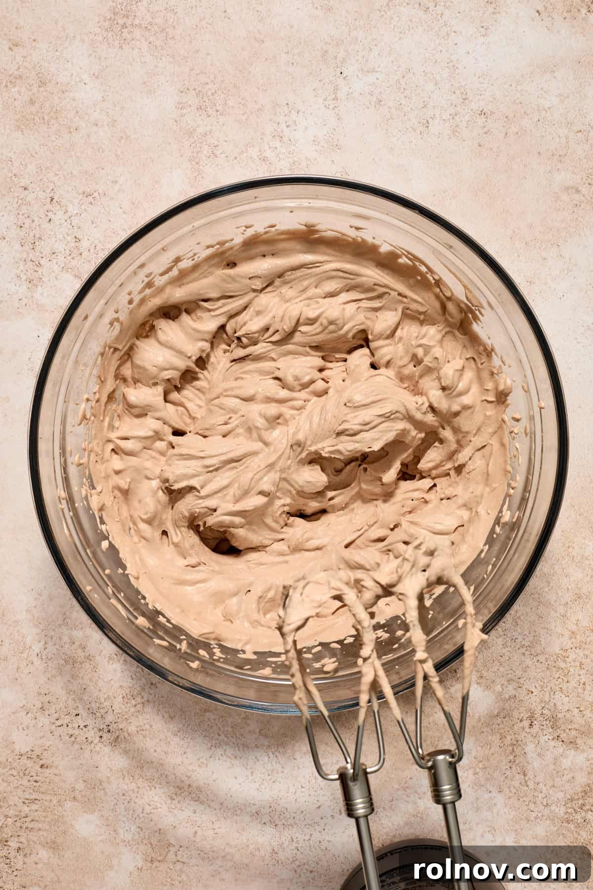 Velvety No Bake Chocolate Pie 10 Chocolate whipped cream in glass bowl with electric beaters.