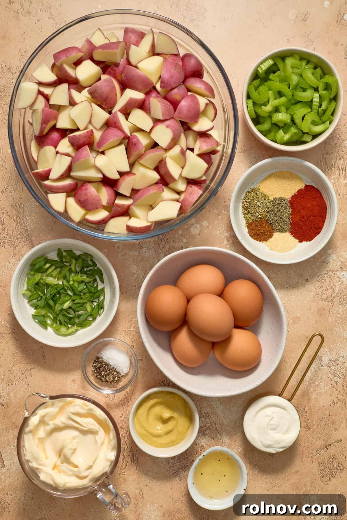 Bayou Potato Salad 3 Potatoes, eggs, celery, mayo and other ingredients arranged on a rustic wooden surface.