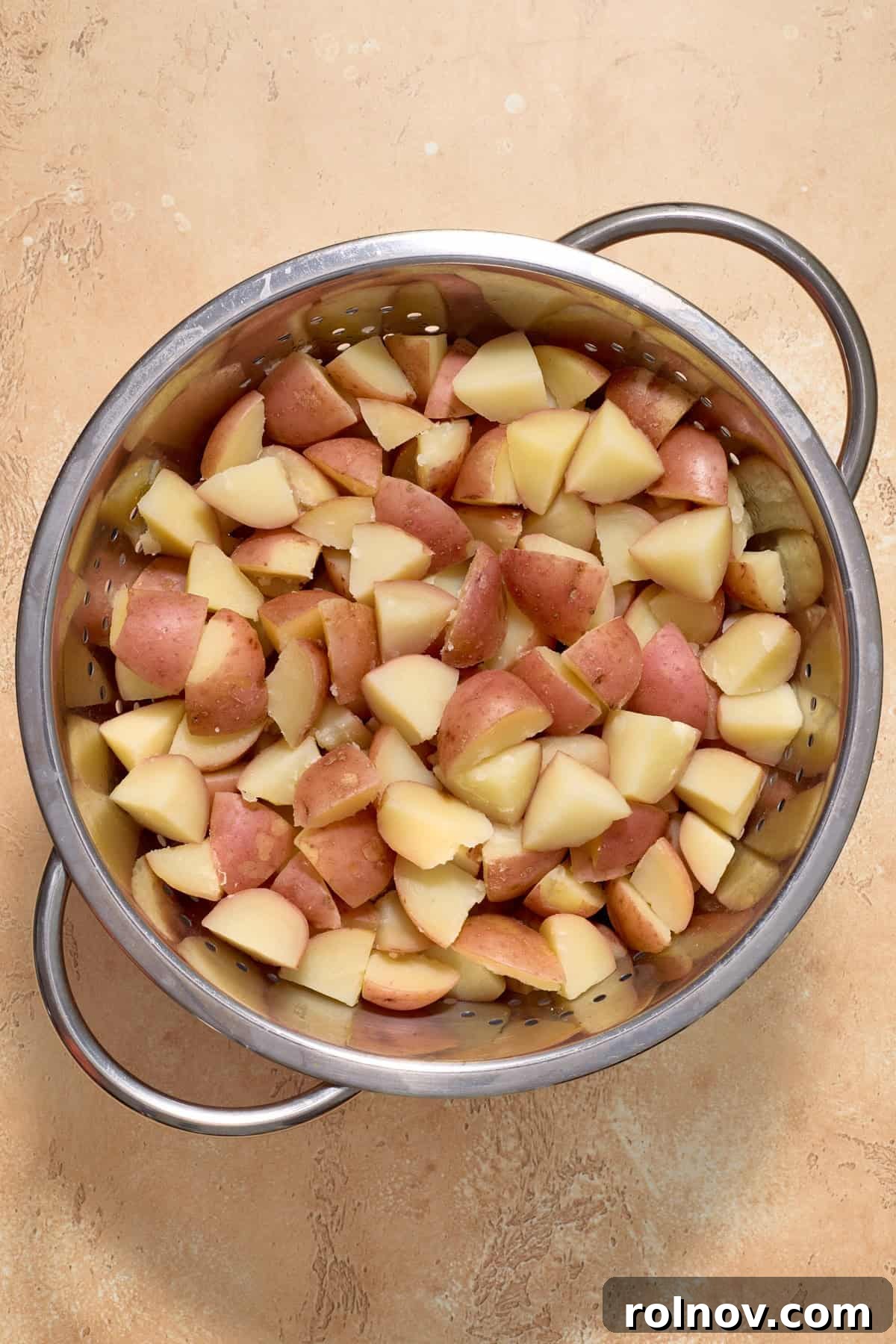 Bayou Potato Salad 4 Potatoes cooked in a large metal pot, ready to be drained.