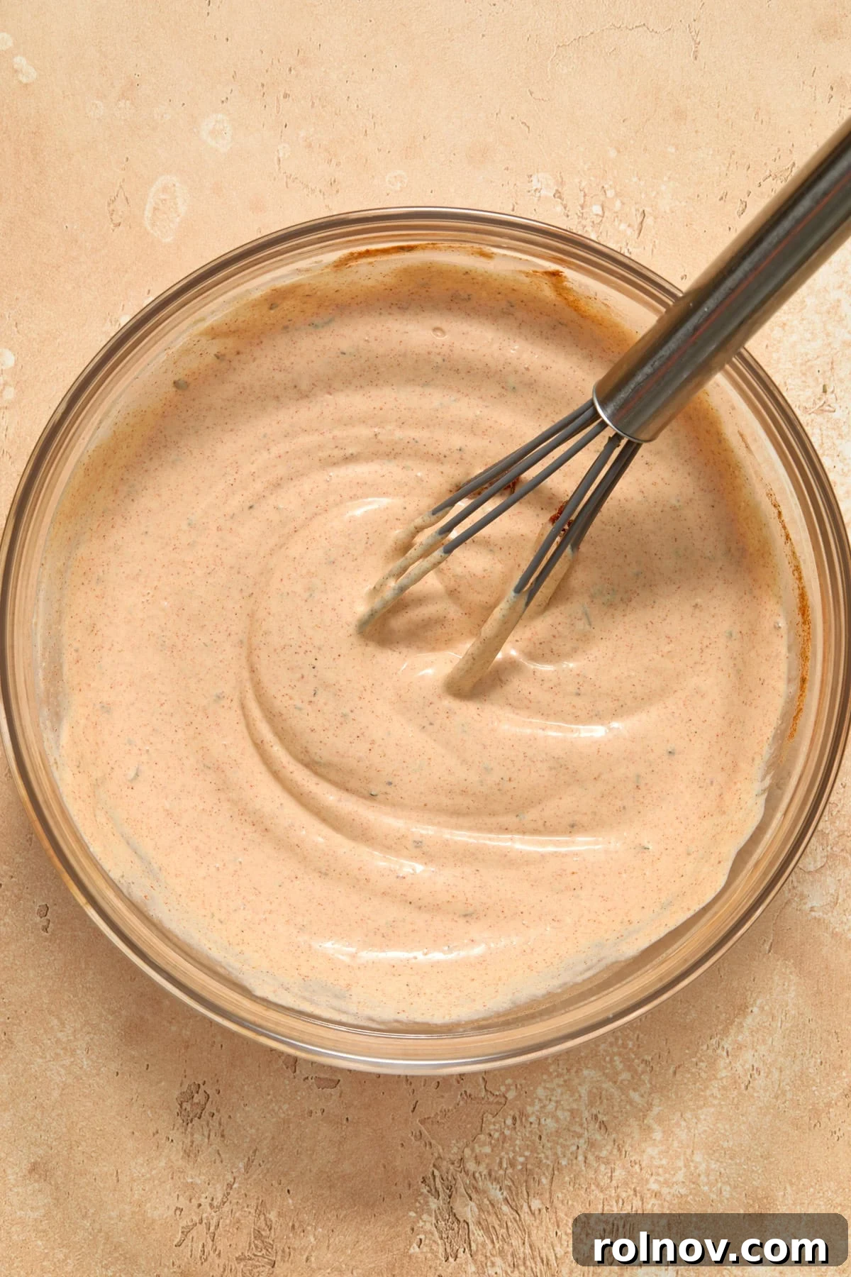 Bayou Potato Salad 7 Smooth, creamy Cajun dressing in a bowl with a whisk resting in it.