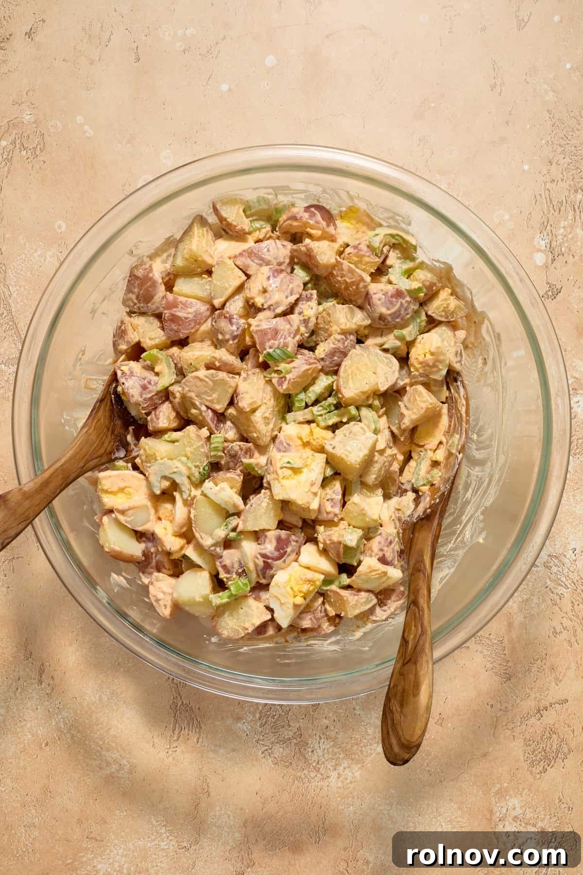 Bayou Potato Salad 9 Cajun potato salad in a glass bowl after being tossed with dressing, ready for garnishing.