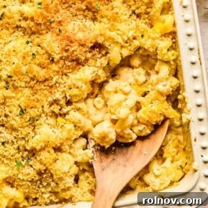 Macaroni and cheese in pan baked with breadcrumbs and chopped parsley on top.