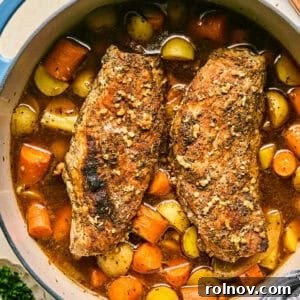 Dutch oven with roasted pork tenderloin, carrots and potatoes.