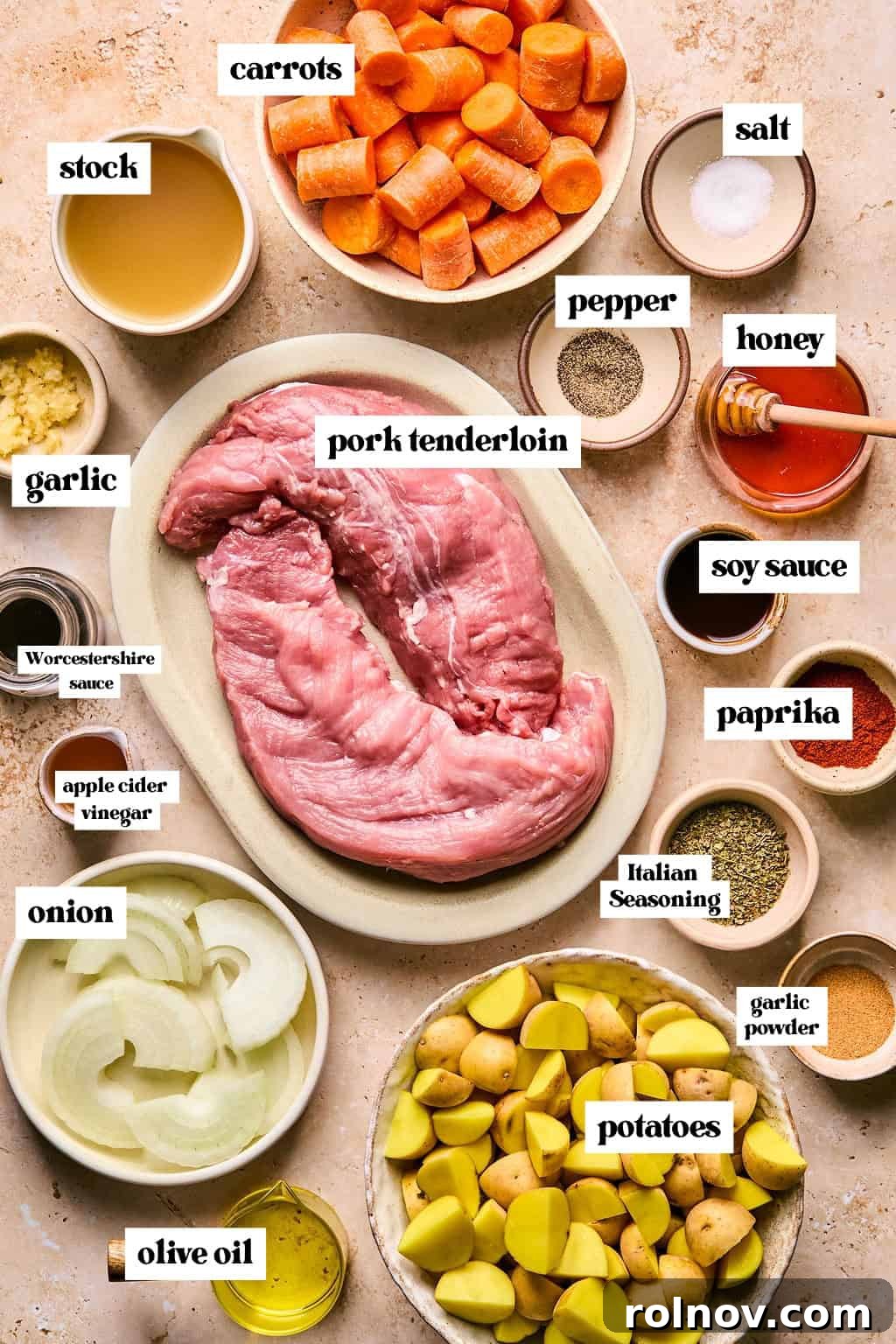 Succulent Dutch Oven Pork Tenderloin 3 Labeled ingredients arranged on surface including pork tenderloin, carrots, potatoes, seasoning and more.