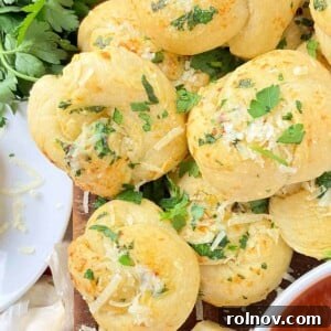 Elevate Your Gnocchi Side Dishes That Shine 15 Garlic knots on cutting board with freshly chopped parsley.
