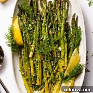 Elevate Your Gnocchi Side Dishes That Shine 18 Lemon herb roasted asparagus on white plate with lemons.