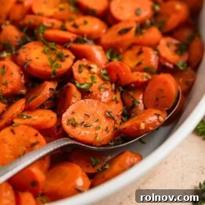 Elevate Your Gnocchi Side Dishes That Shine 23 Serving spoon scooping into carrots in white dish.