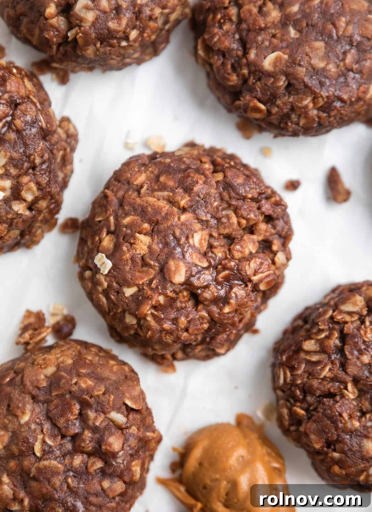 No bake cookie butter cookie on parchment with crumbs.