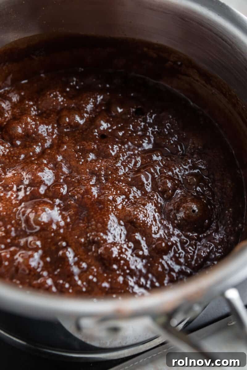 Boiling chocolate mixture in saucepan.