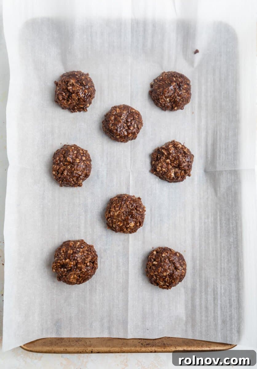 Cookie butter cookies spooned on parchment lined cookie sheet.