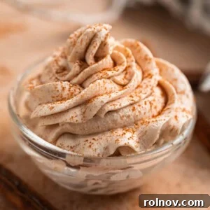 Autumn's Pumpkin Cloud 9 Pumpkin spice whipped cream piped in glass bowl with cinnamon dusted over top.