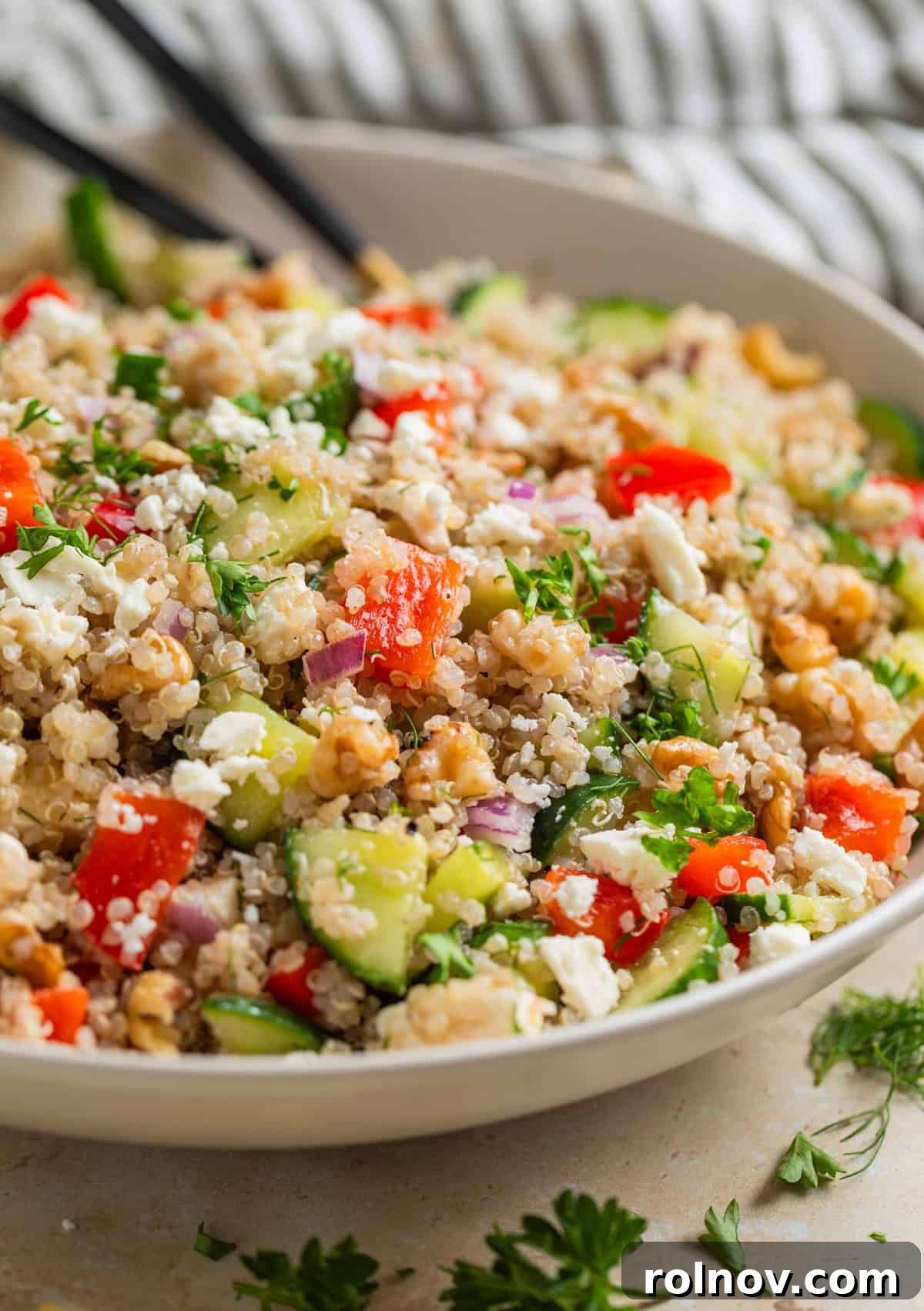 Zesty Cucumber Feta Quinoa Bowl 5 A vibrant serving bowl overflowing with the finished Cucumber Quinoa Feta Salad, garnished with extra fresh dill and feta, highlighting its fresh, Mediterranean appeal.