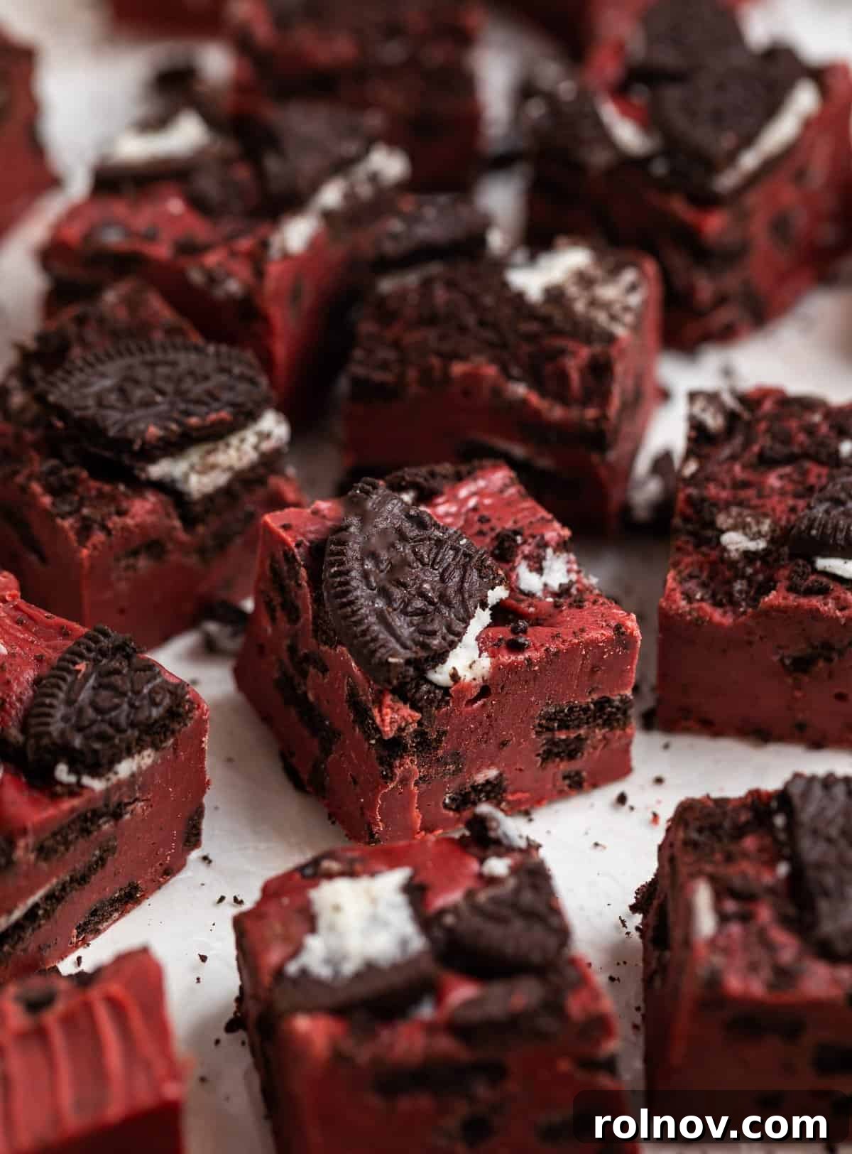 Red velvet fudge with Oeos sitting on wax paper.