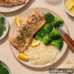 Perfect Pairings for Brussels Sprouts 5 Plate with herbed salmon served with broccoli and rice with lemon wedges.