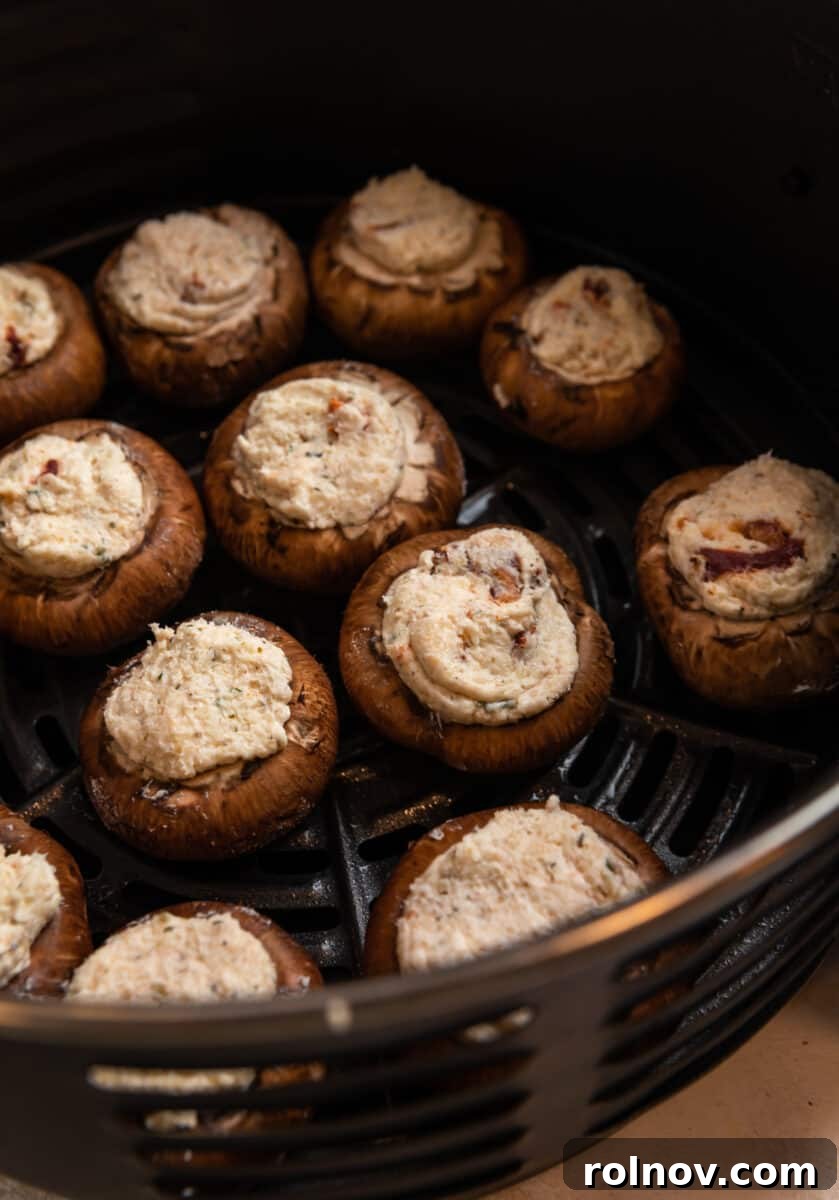 Savory Air Fryer Stuffed Mushrooms 6 Stuffed mushrooms in air fryer before cooked.