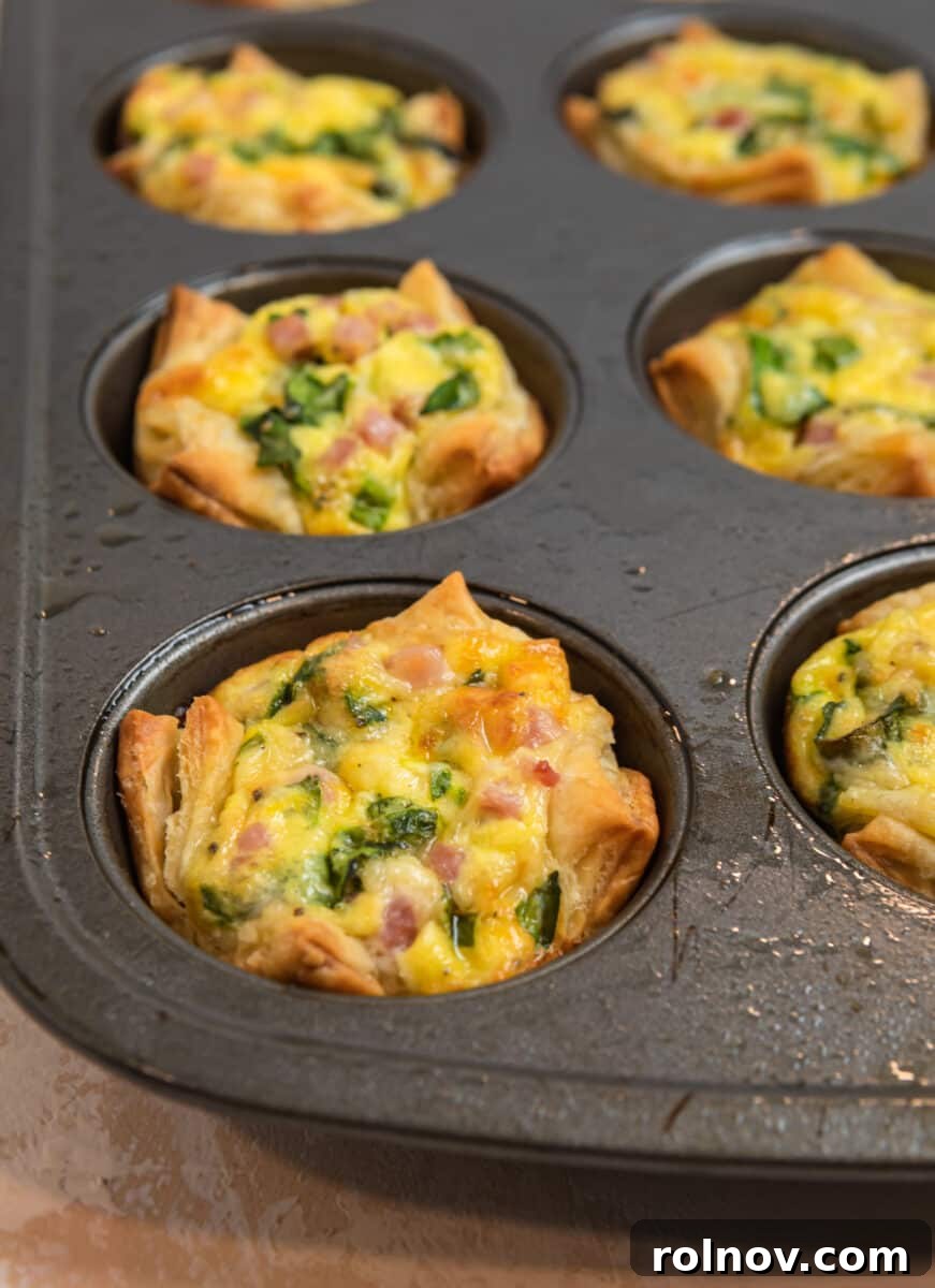 Buttery Flaky Quiche 12 Puff pastry mini quiches in muffin tin cooled off.