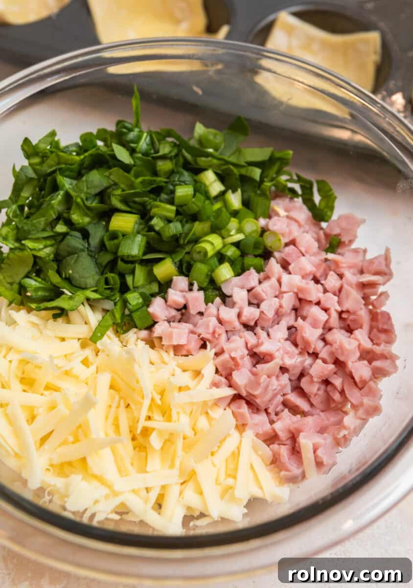 Buttery Flaky Quiche 4 Ham, cheese, onion, and spinach in glass mixing bowl.